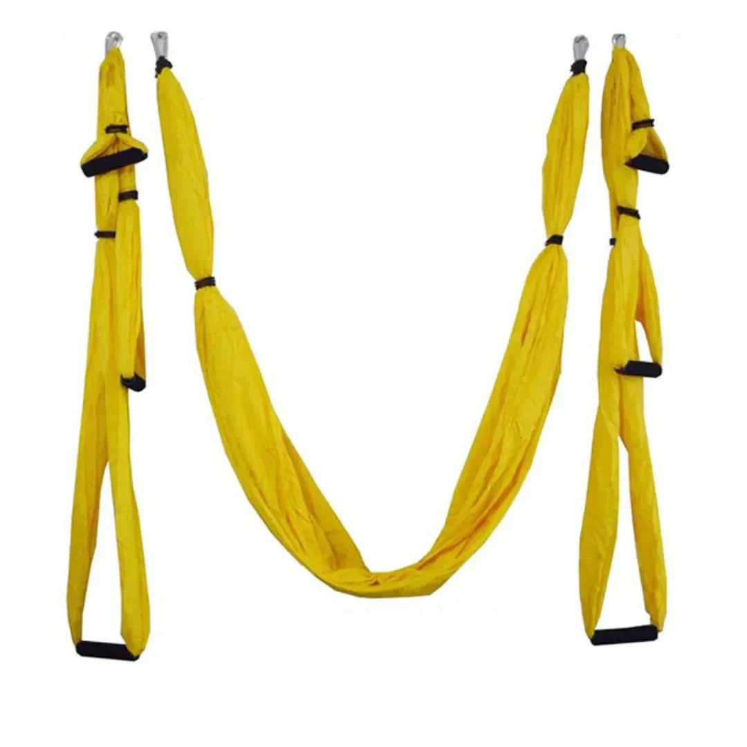 Yellow yoga hammock with black straps on a white background