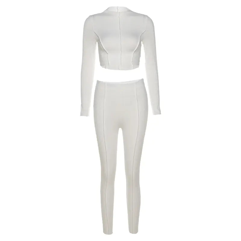 White two-piece outfit with a crop top and high-waisted pants on a white background
