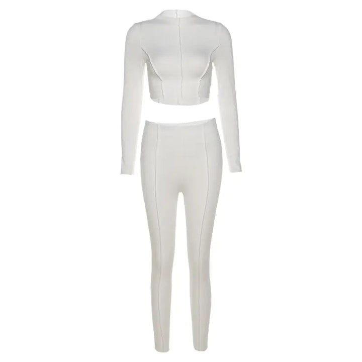 White two-piece outfit with a crop top and high-waisted pants on a white background
