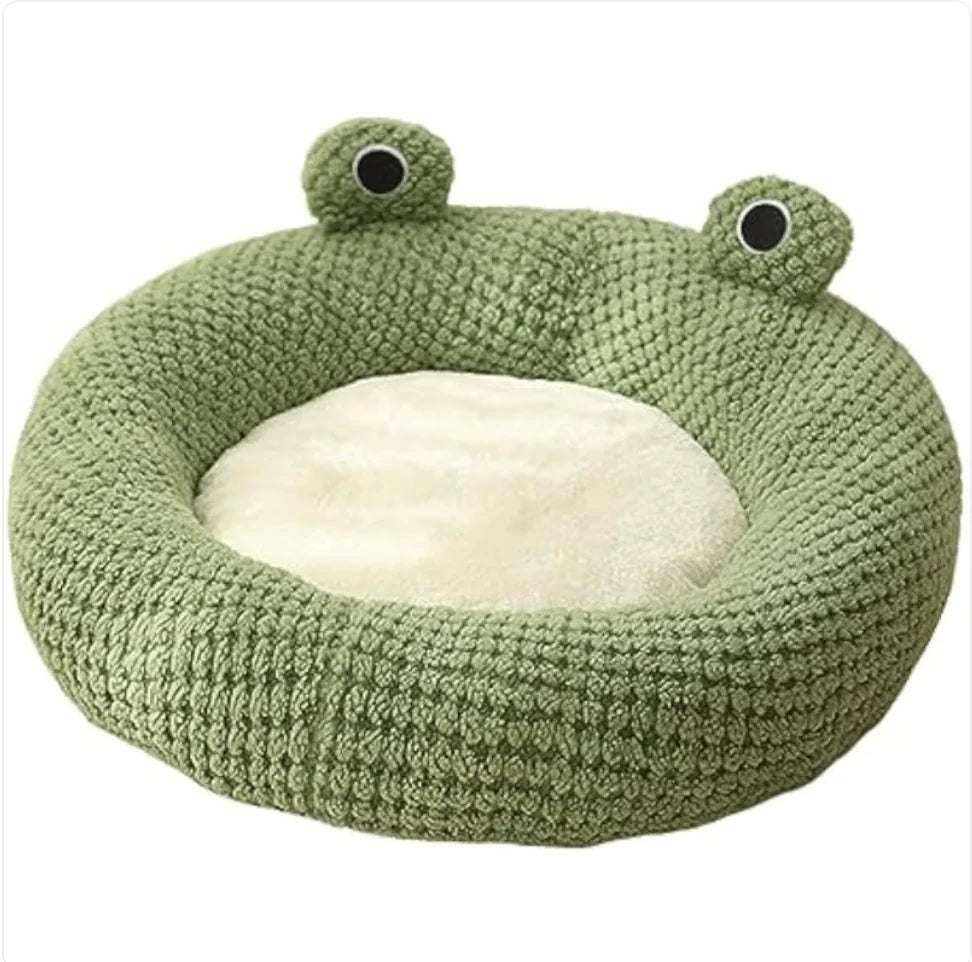 Green frog-shaped pet bed on a white background