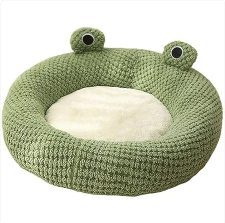 Green frog-shaped pet bed on a white background