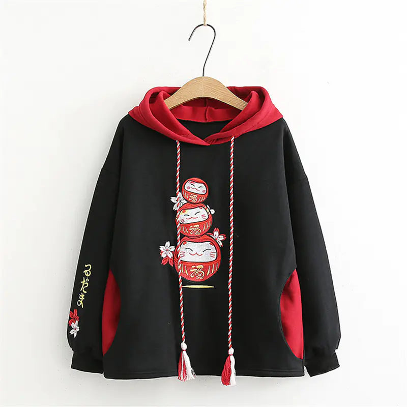 Black hoodie with red accents and decorative elements on a white background
