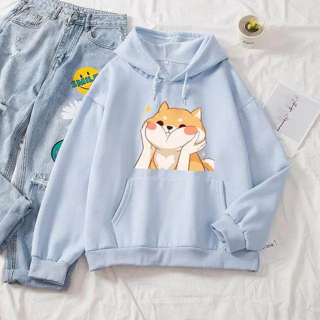 Light blue hoodie with a dog graphic on a white surface