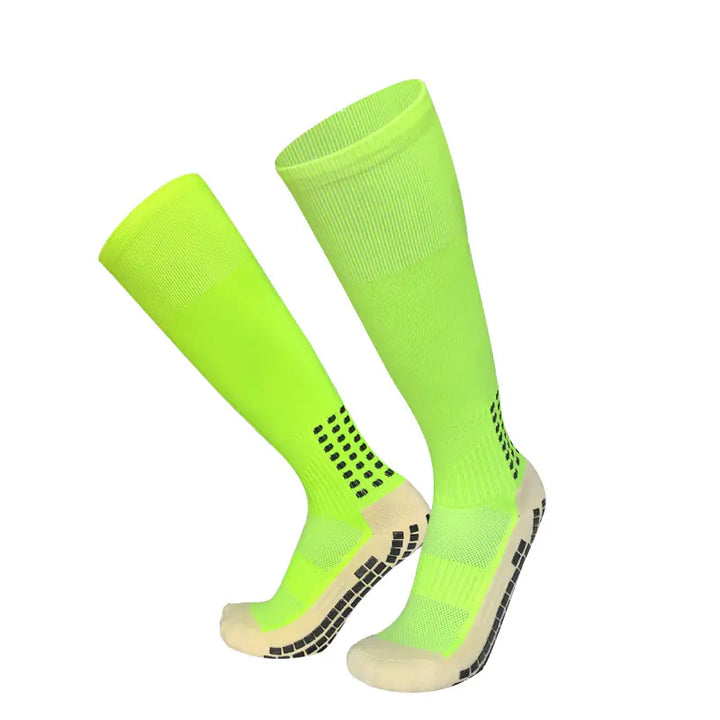 Pair of bright green knee-high socks with black patterns on a white background