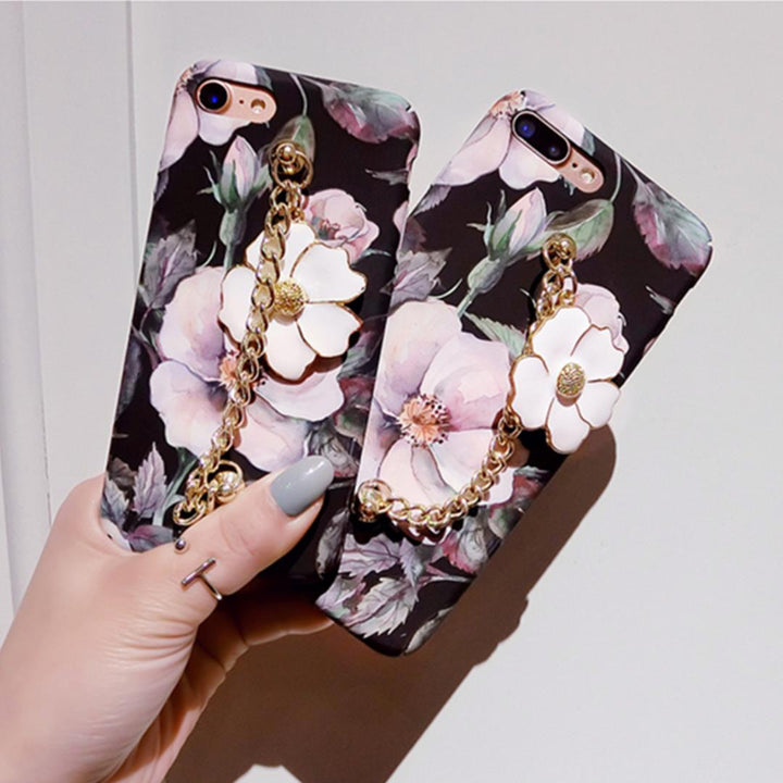 Floral phone case with chain holder held by a hand