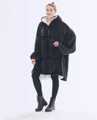 Person wearing a black poncho on a white background