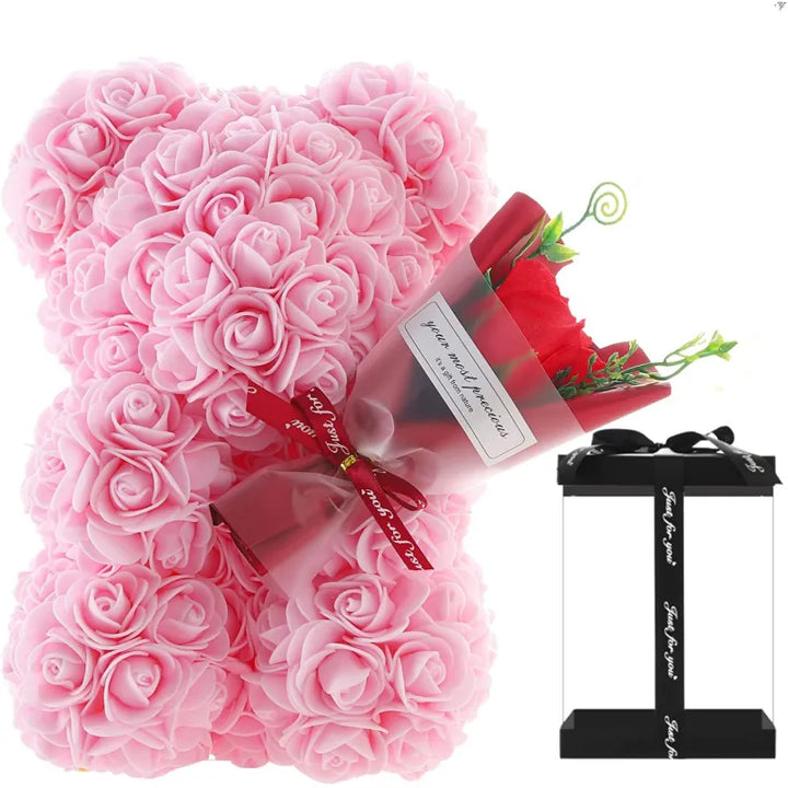 Pink rose teddy bear with a red rose and gift box on a white background