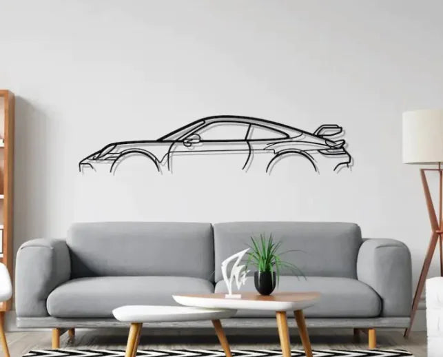 Car wall decal on a white wall above a gray sofa in a living room.