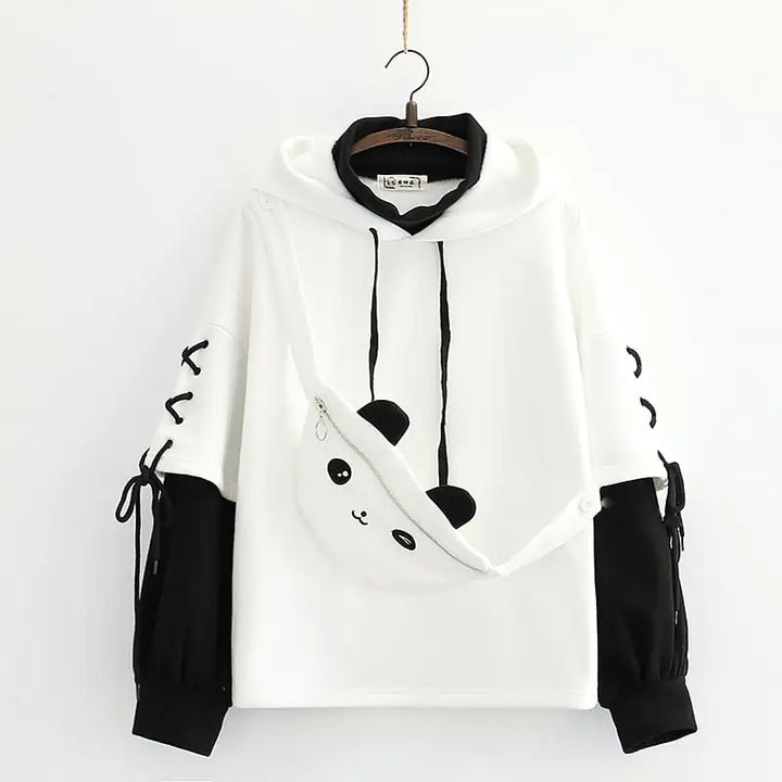 White hoodie with black accents on a hanger against a white background
