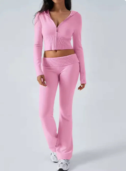 Person wearing a pink tracksuit on a light gray background