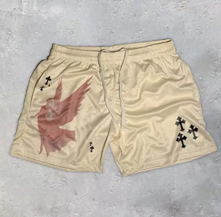 Beige shorts with a red graphic and black crosses on a gray surface