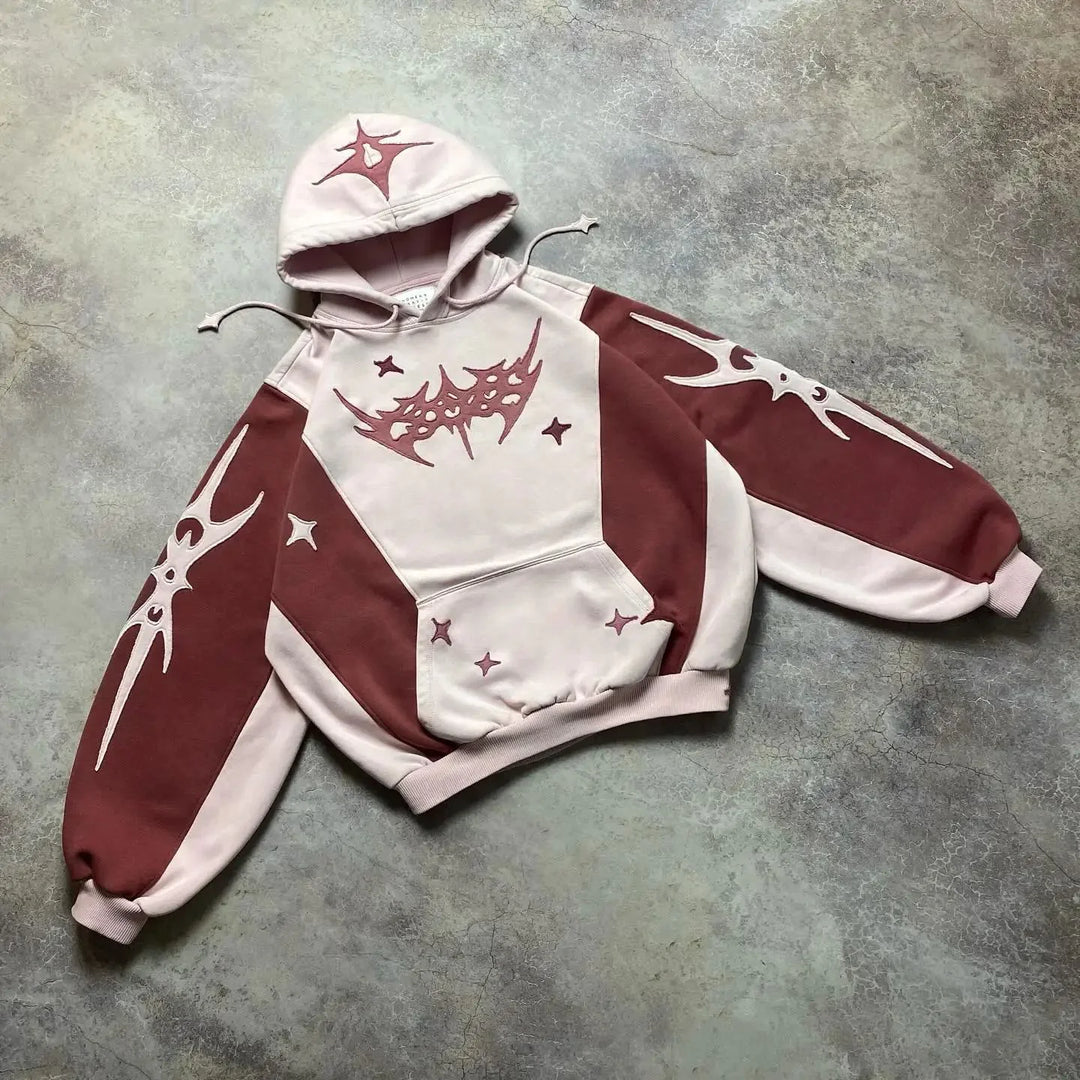 Hoodie with red and white design on a gray surface