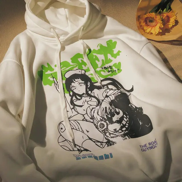 White hoodie with graphic design of a character and text on a neutral background